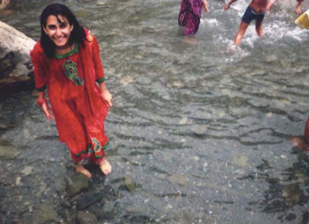Rachana Rajendra smiling in a shallow river